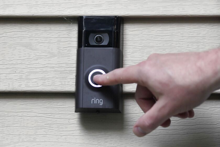 FILE - In this July 16, 2019, file photo, Ernie Field pushes the doorbell on his Ring doorbell camera at his home in Wolcott, Conn. Amazon says it has considered adding facial recognition technology to its Ring doorbell cameras. The company said in a letter released Tuesday, Nov. 19 by U.S. Sen. Ed Markey that facial recognition is a “contemplated, but unreleased feature” of its home security cameras. The Massachusetts Democrat wrote to Amazon CEO Jeff Bezos in September raising privacy and civil liberty concerns about Ring’s video-sharing partnerships with hundreds of police departments around the country. (AP Photo/Jessica Hill, File)