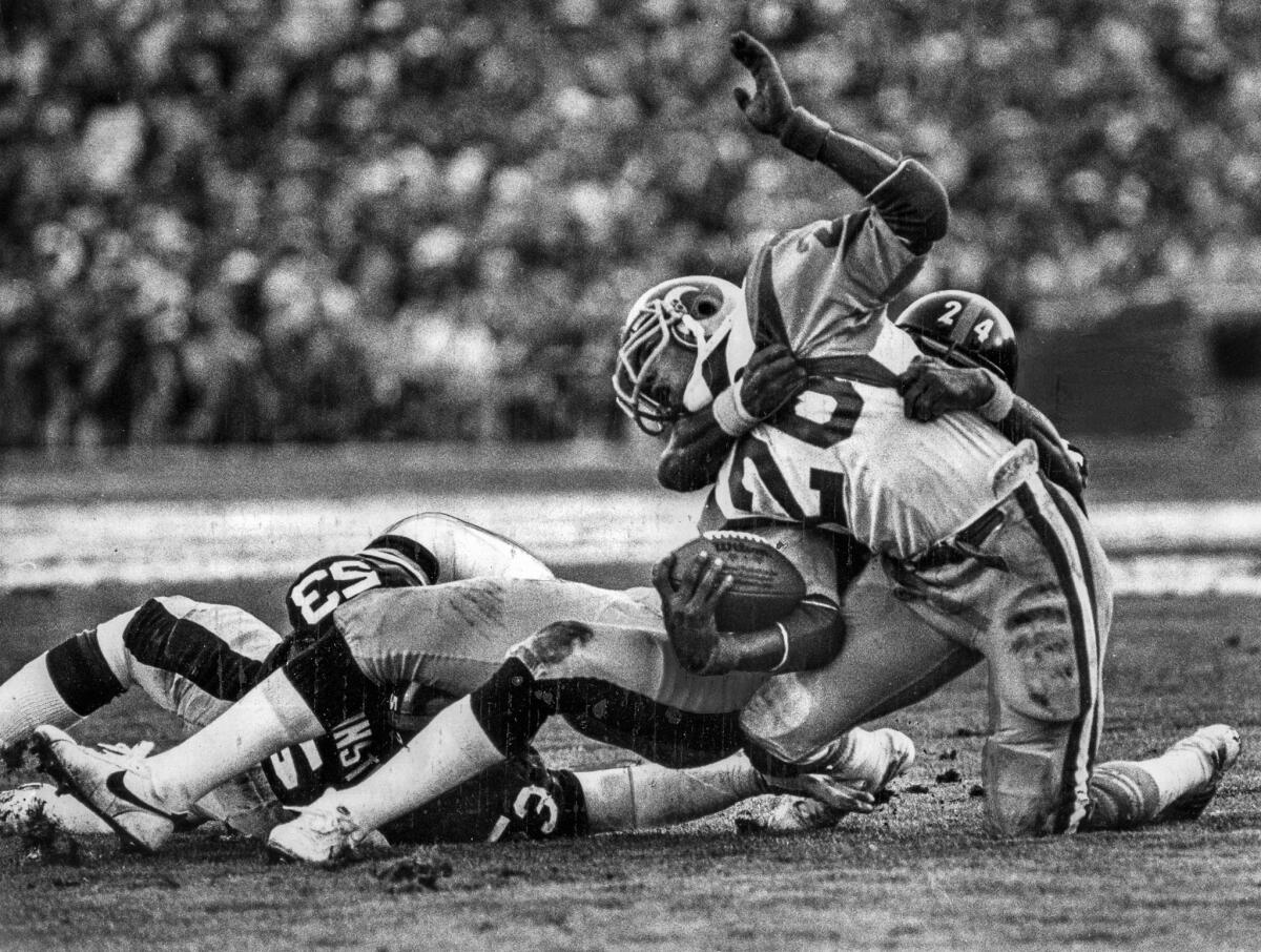 Jan. 20, 1980: Steelers defensive back J.T. Thomas (24) wrestles the Rams' Wendell Tyler (26) to the turf after a short gain in the second quarter.