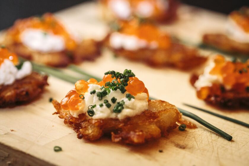 LOS ANGELES, CA - OCTOBER 6 2013: Potato Latkes with Rye Flour, Lemon Cream, and Salmon Roe made by Free Range Los Angeles during Jill Bernheimer's, owner of the wine and spirits store DomaineLA, Champagne tasting at her home, Sunday, October 6, 2013, in Los Angeles, CA. Bernheimer invited friends into her home to taste Champagne's that she will carry in her store for the Holiday season. The event was catered by Free Range Los Angeles. (Bret Hartman/ For The Times)