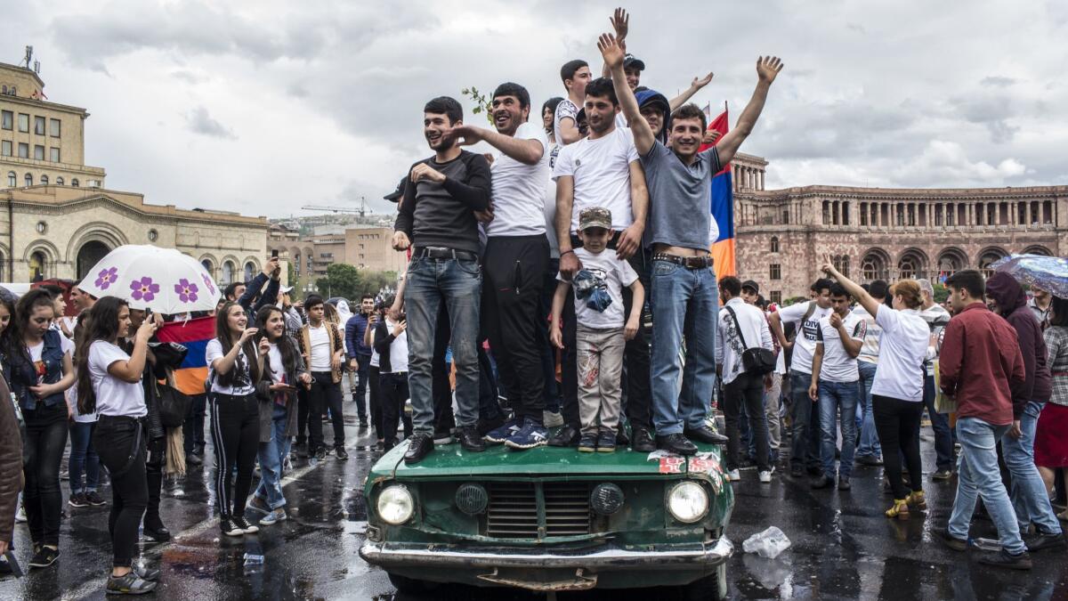 Armenians celebrate after a rally in support of protest leader Nikol Pashinian in Yerevan's Republic Square after he was elected prime minister by parliament.