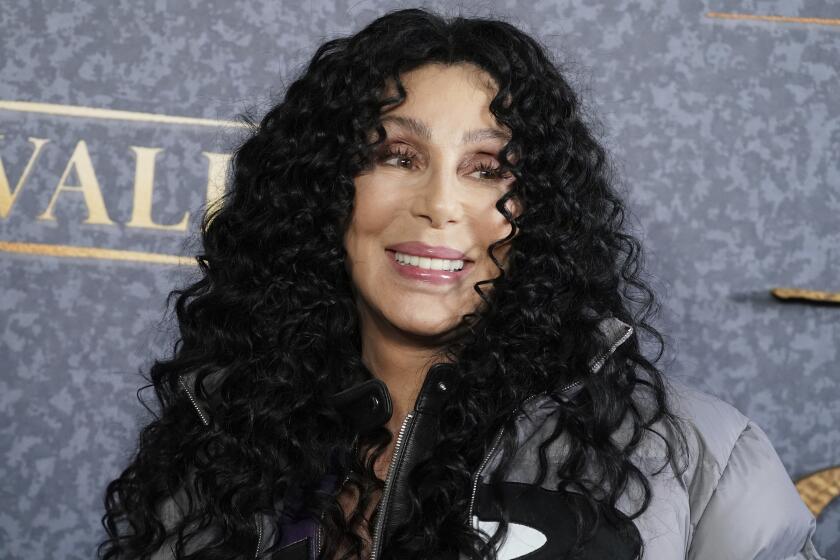 Cher smiles at a premiere