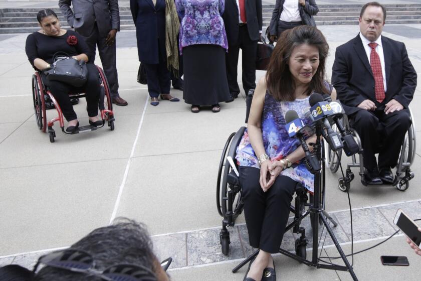 LOS ANGELES CA. JUNE 7, 2017: Whistleblower Mei Ling speaks, with her attorney Scott Moore behind her, during a media availability on June 7, 2017, outside the U.S. Courthouse in Los Angeles. The U.S. Intervened in the âWhistleblowerâ Lawsuit against City of Los Angeles that Alleges City Received Millions of Dollars in Federal Grants and knowingly failed to Provide Housing Accessible to the Disabled. (Glenn Koenig/ Los Angeles Times)