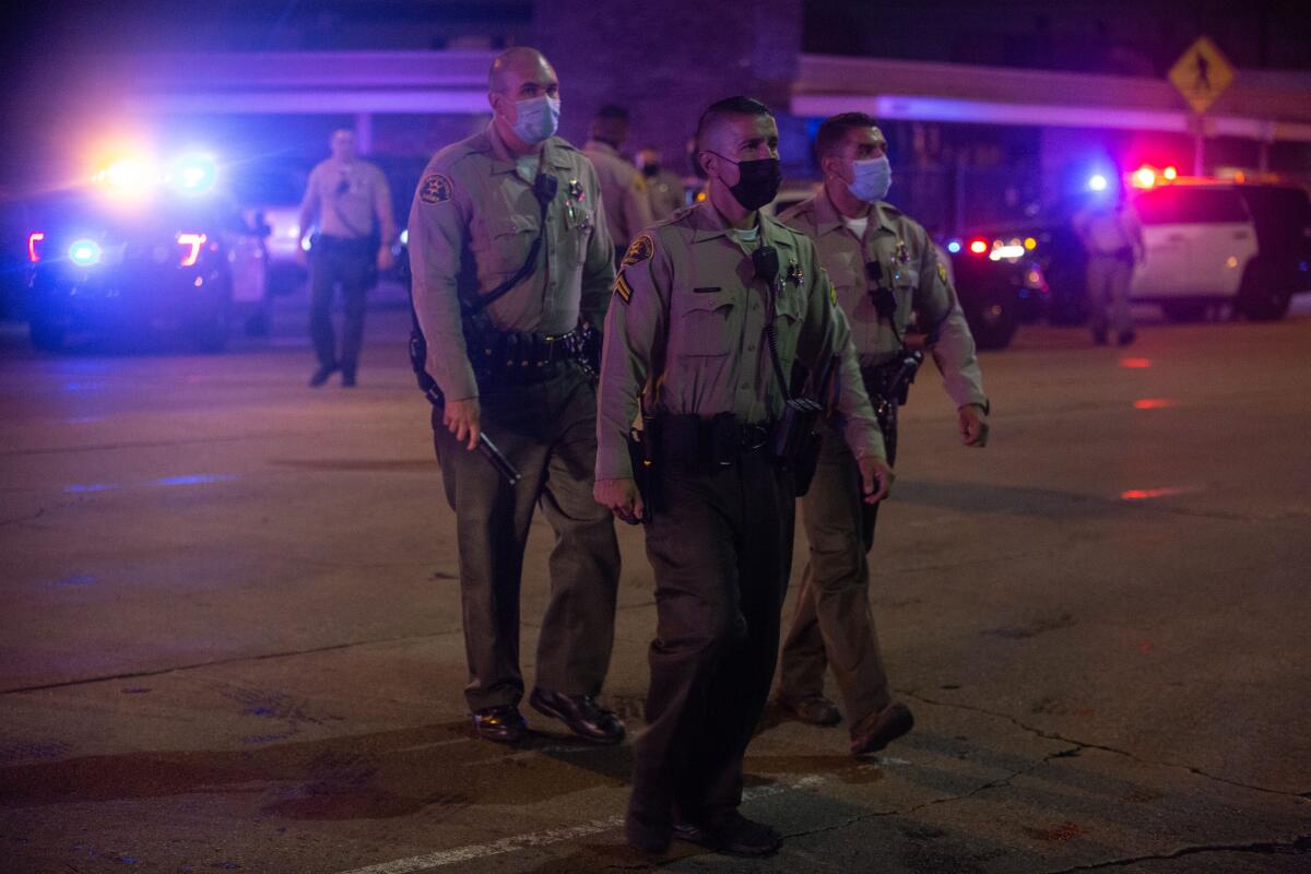 Los Angeles County sheriff's deputies gather at St. Francis Medical Center after two deputies were shot.