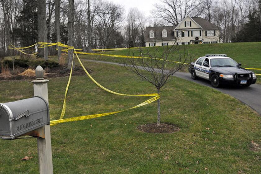 Police tape surrounds the home of Nancy Lanza, who was killed by her son, Adam Lanza. Adam Lanza also killed children and others at Sandy Hook Elementary School in Newtown, Conn.