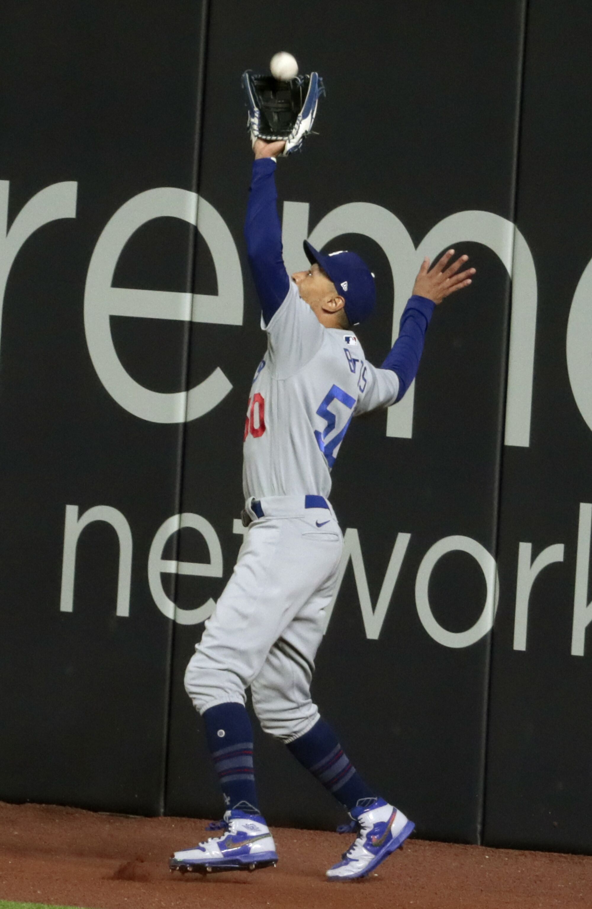 Dodgers right fielder Mookie Betts makes a catch on a sacrifice fly during the first inning.