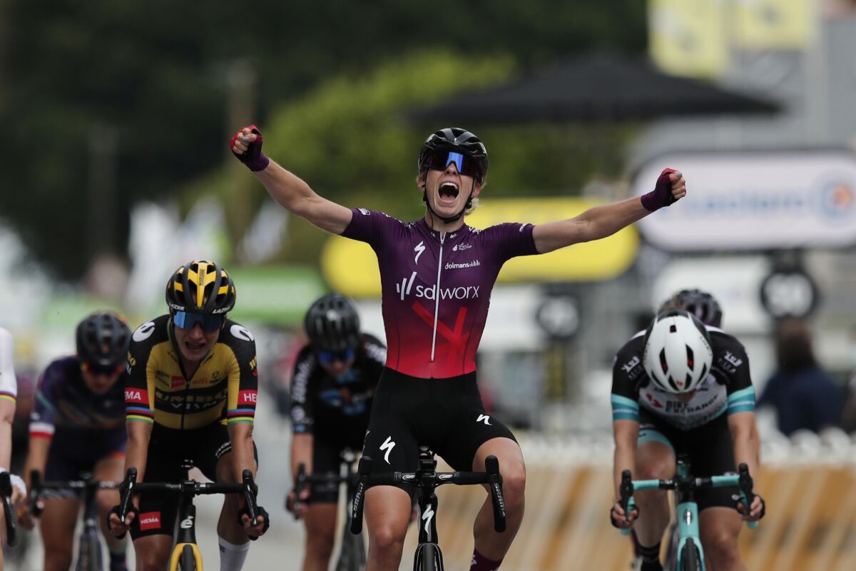 Netherland's Demi Vollering of the SD Worx celebrates as she crosses the finish line to win La Course by Le Tour de France women's cycling race, in Landernau, France, Saturday, June 26, 2021. (Benoit Tessier, Pool Photo via AP)
