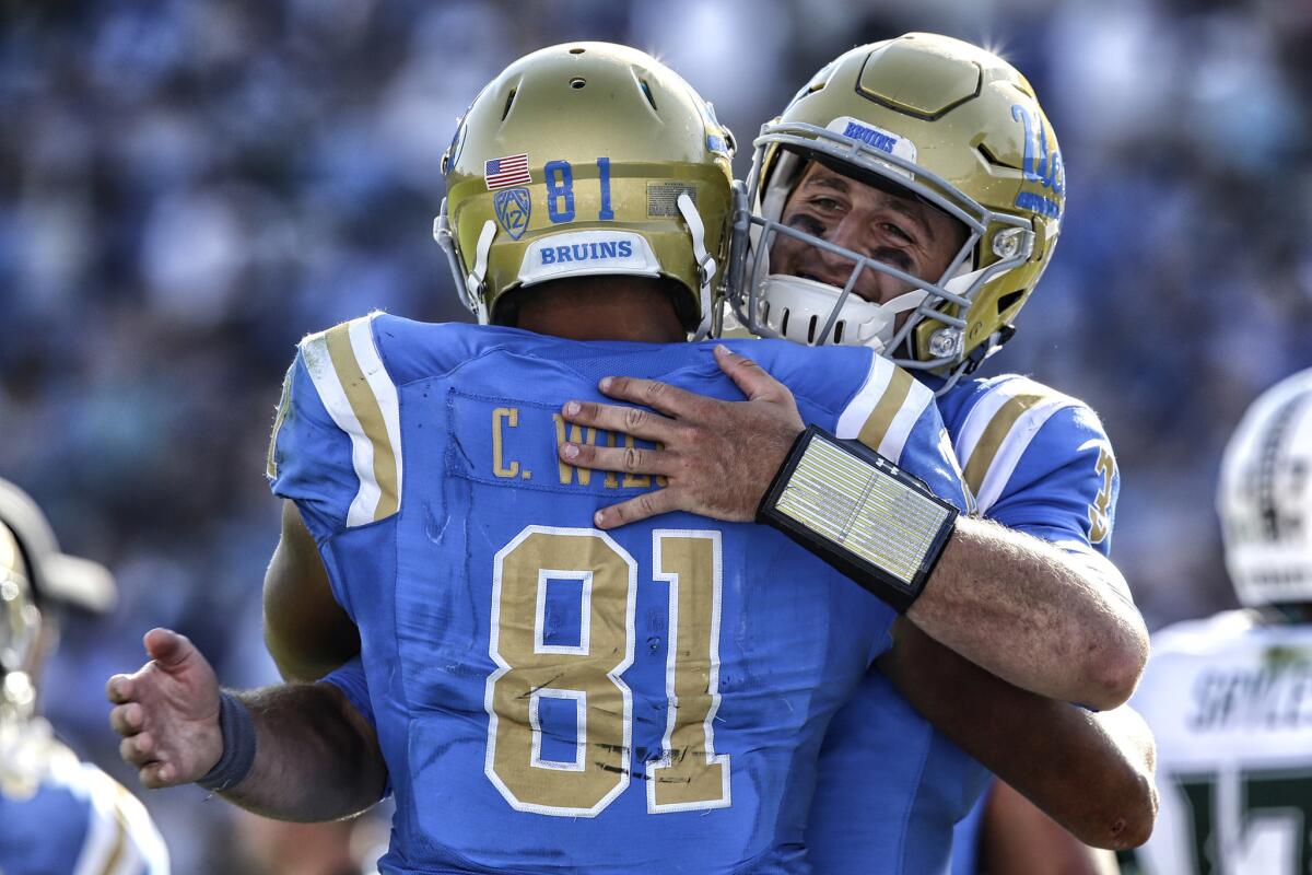UCLA quarterback Josh Rosen hugs tight end Caleb Wilson after they connected on a second-half touchdown against Hawaii at the Rose Bowl on Saturday.