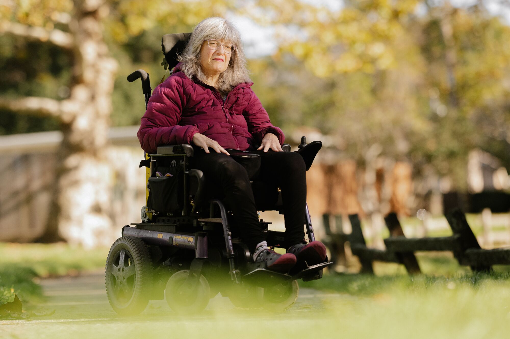 A woman sits in a wheelchair.
