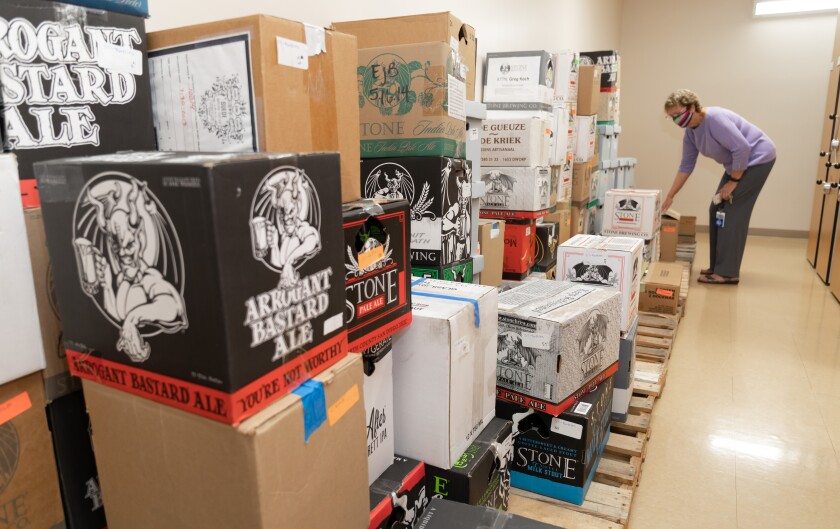 Brewchive curator Judith Downie goes through more than 100 boxes of Stone Brewing beer bottles in the special collection.