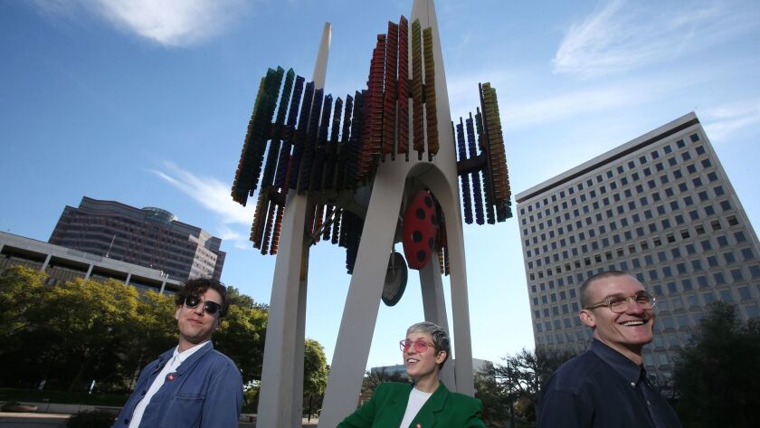 Jona Bechtolt, left, Claire Evans and Tom Carroll are heading an effort to restore the neglected kinetic sculpture called the Triforium in downtown Los Angeles.