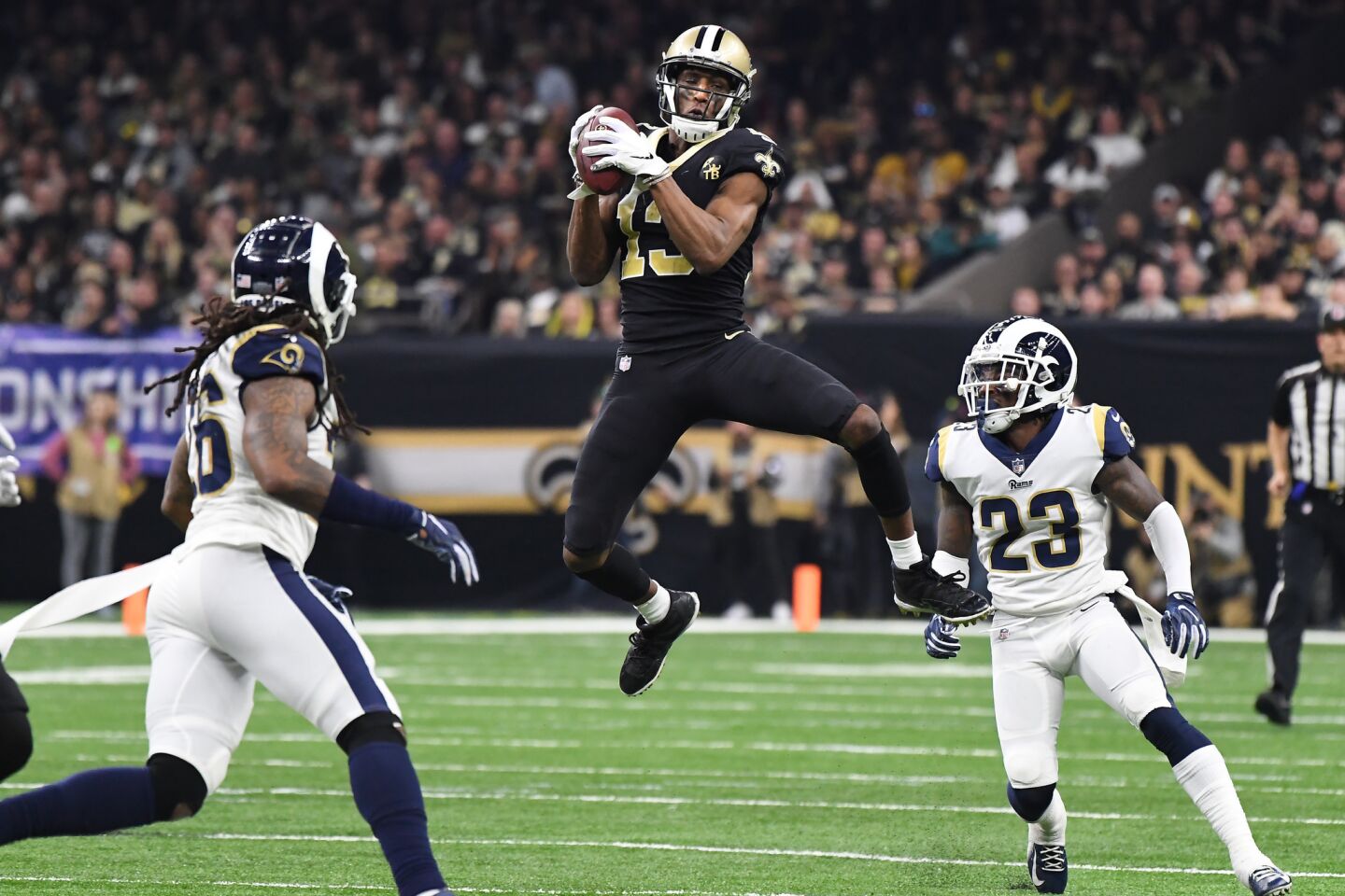 New Orleans Saints receiver receiver Michael Thomas makes a catch in fornt of Rams' Nickell Robey-Coleman (23) in the third quarter in the NFC Championship at the Superdome in New Orleans Sunday.