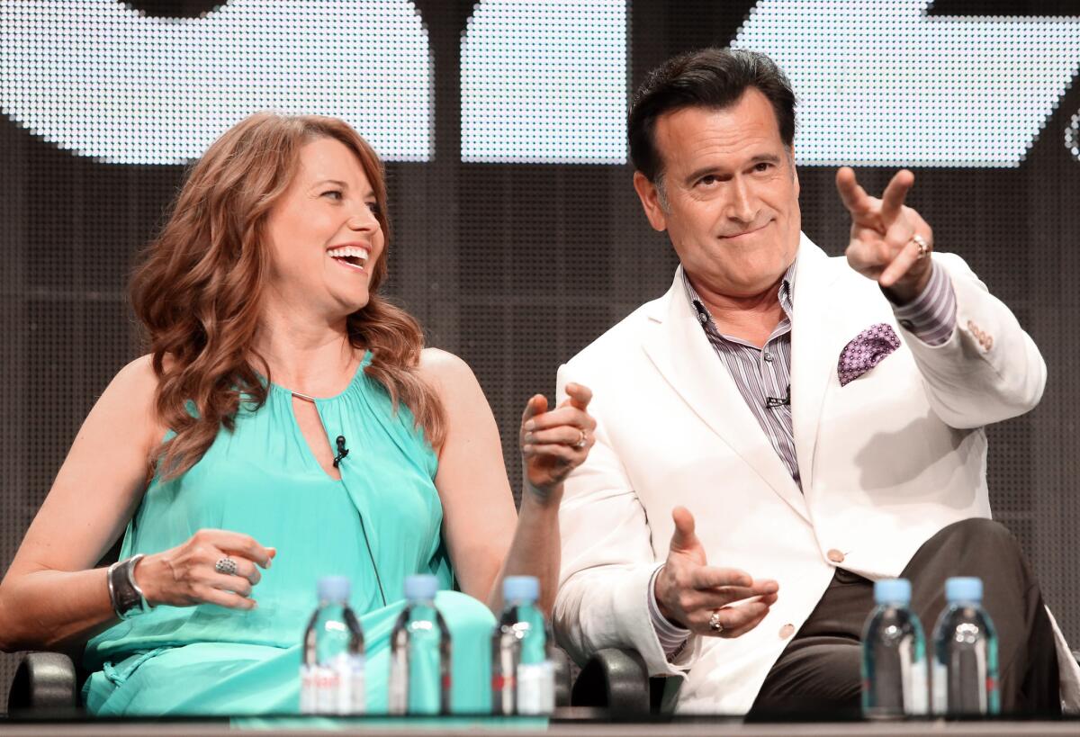 Lucy Lawless and Bruce Campbell during the "Ash vs. Evil Dead" panel at Starz's TCA presentation.
