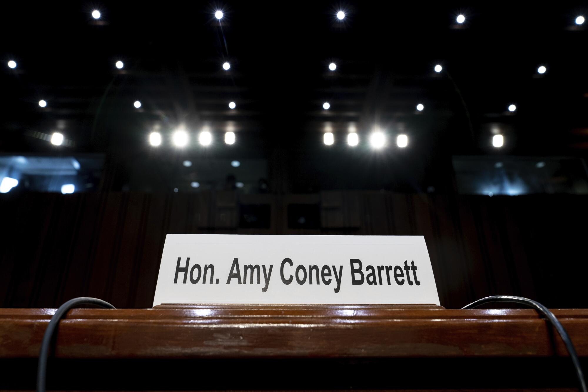 A namecard for Supreme Court nominee Amy Coney Barrett rests on a desk.