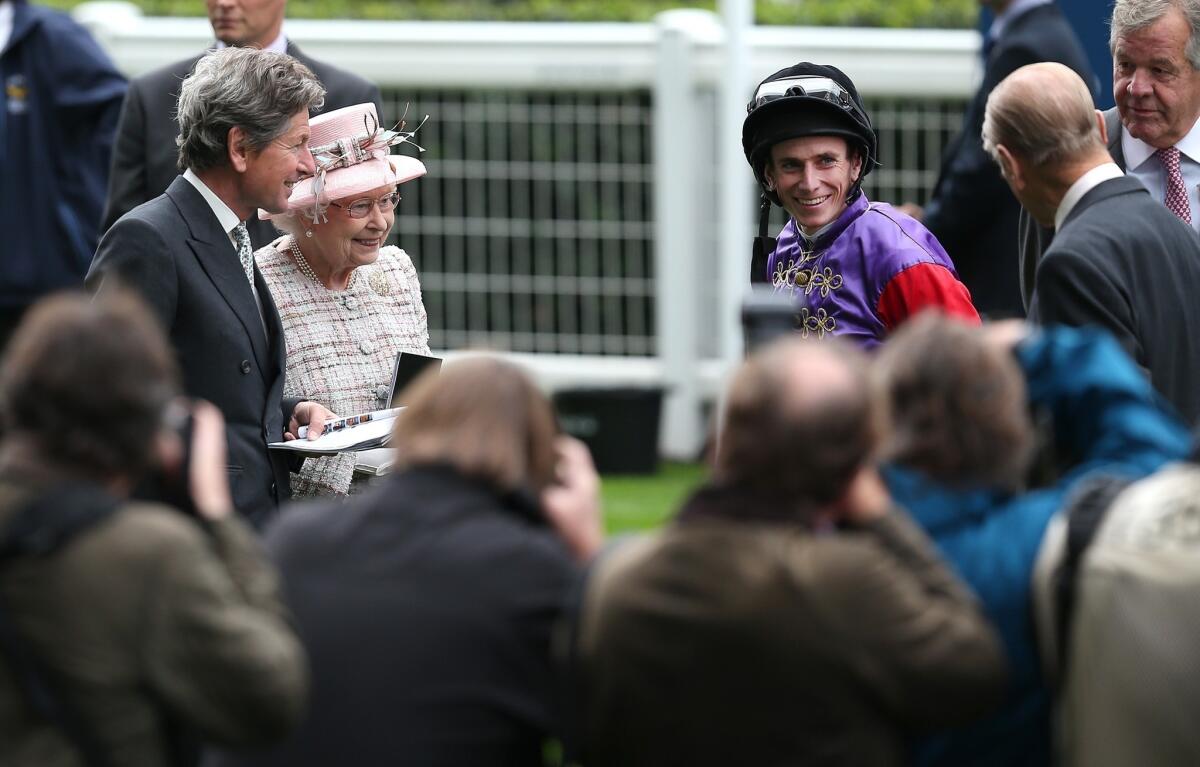 Jockey Ryan Moore, right, speaks with Queen Elizabeth II and Prince Phillip, far right, at Ascot Park in England earlier this month. The accomplished jockey is taking part in the Breeders' Cup at Santa Anita.