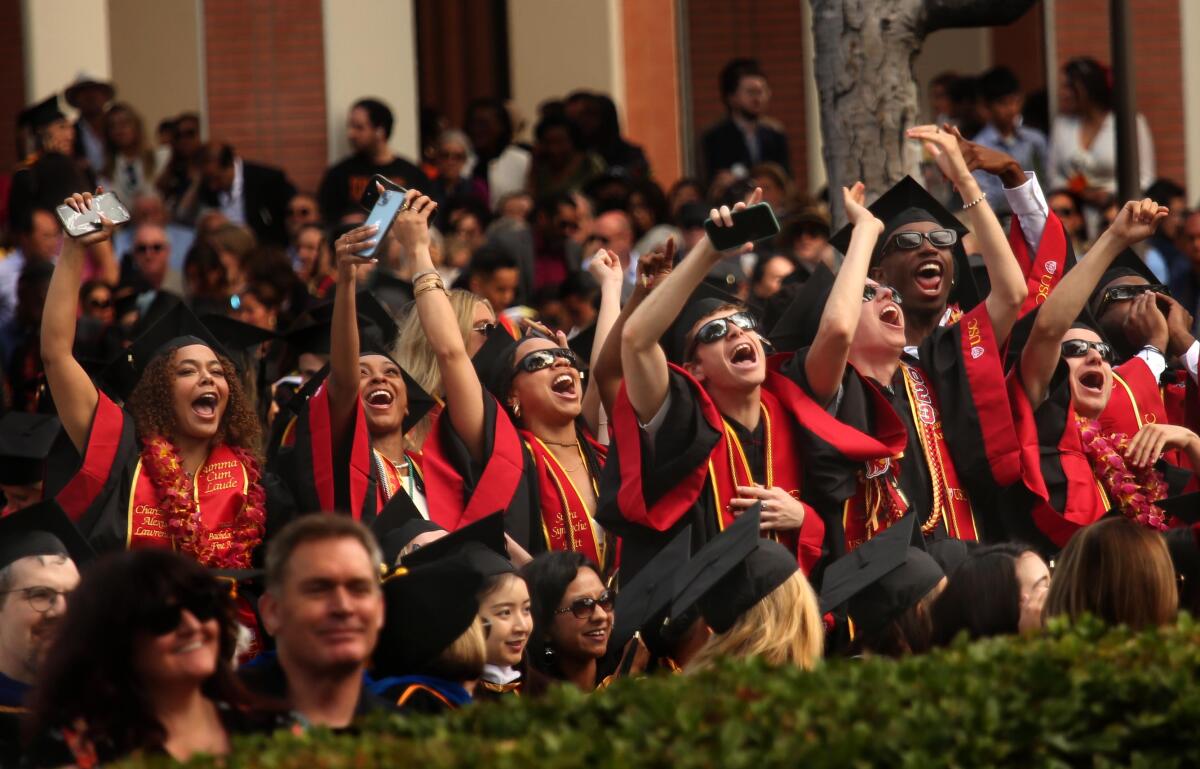 USC graduates cheer at commencement. 