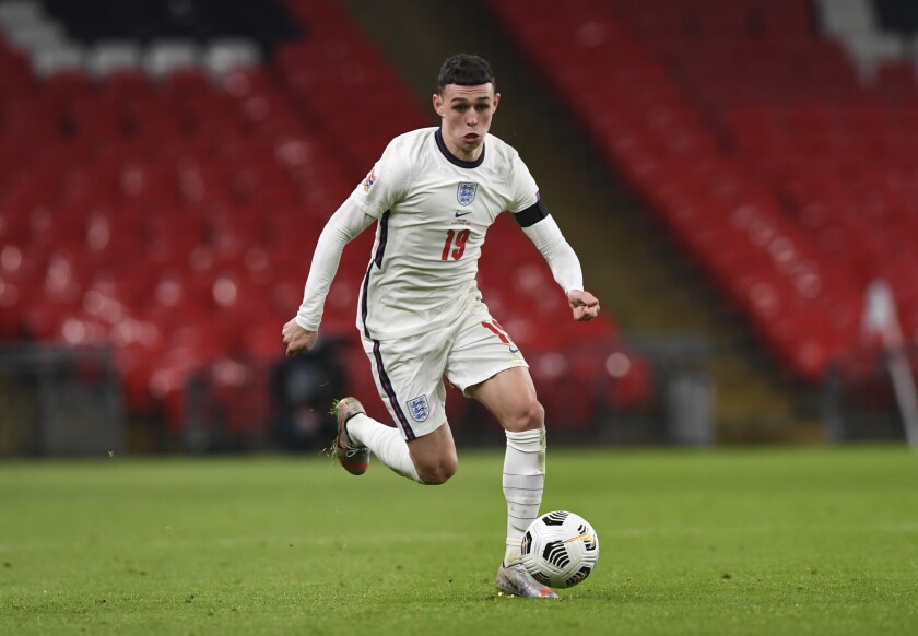 FILE - In this Wednesday, Nov. 18, 2020 filer, England's Phil Foden controls the ball during the UEFA Nations League soccer match between England and Iceland at Wembley stadium in London. Exciting talents like Phil Foden, Joao Felix and Ferran Torres are among a host of young players set to play their first major international tournaments at Euro 2020. UEFA has expanded squads from 23 players to 26 and that could encourage coaches to take a chance on more up-and-comers. (Neil Hall/Pool via AP, File)