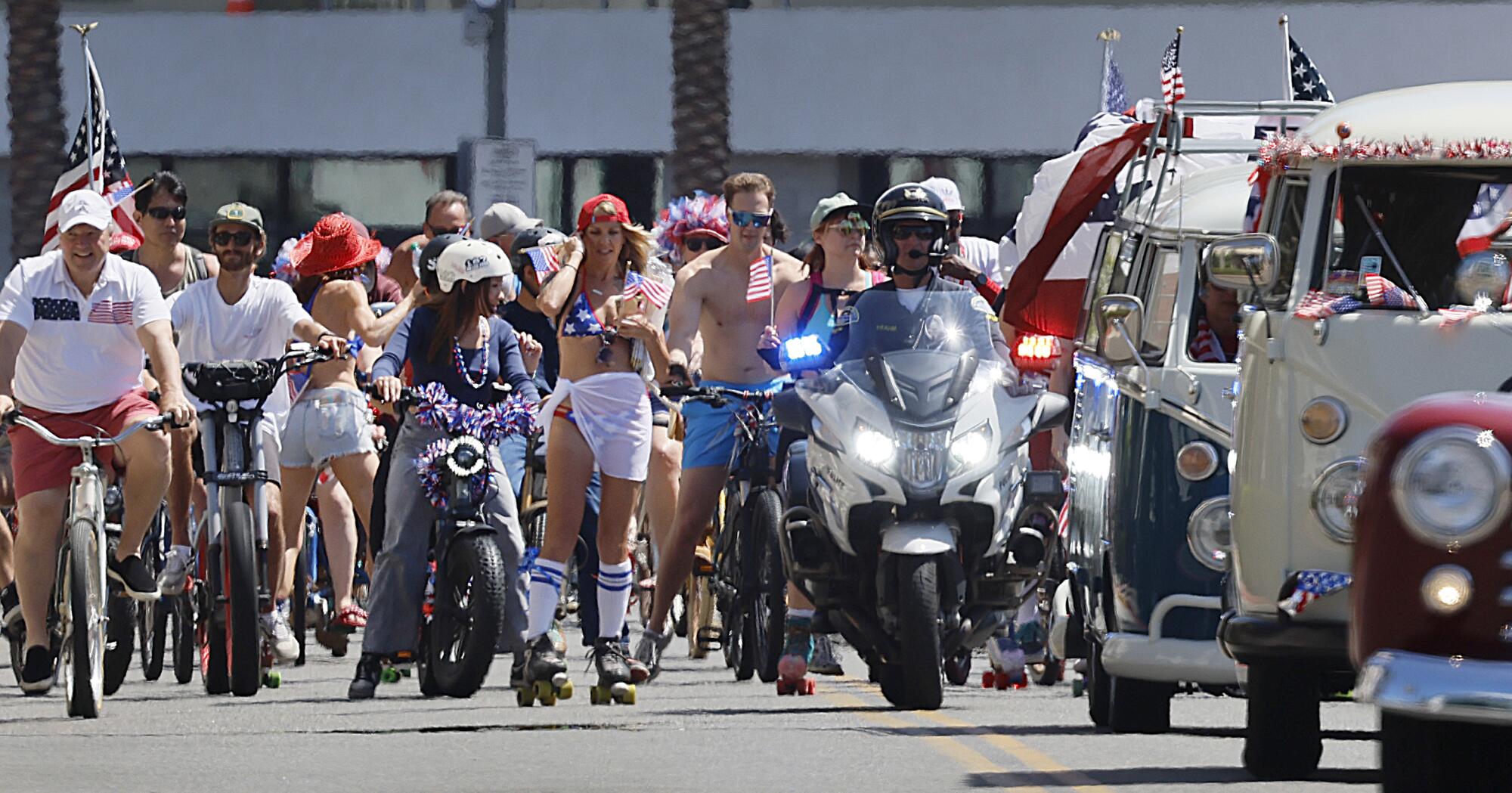 Hundreds of patriotic bicyclists cruise down Main Street.