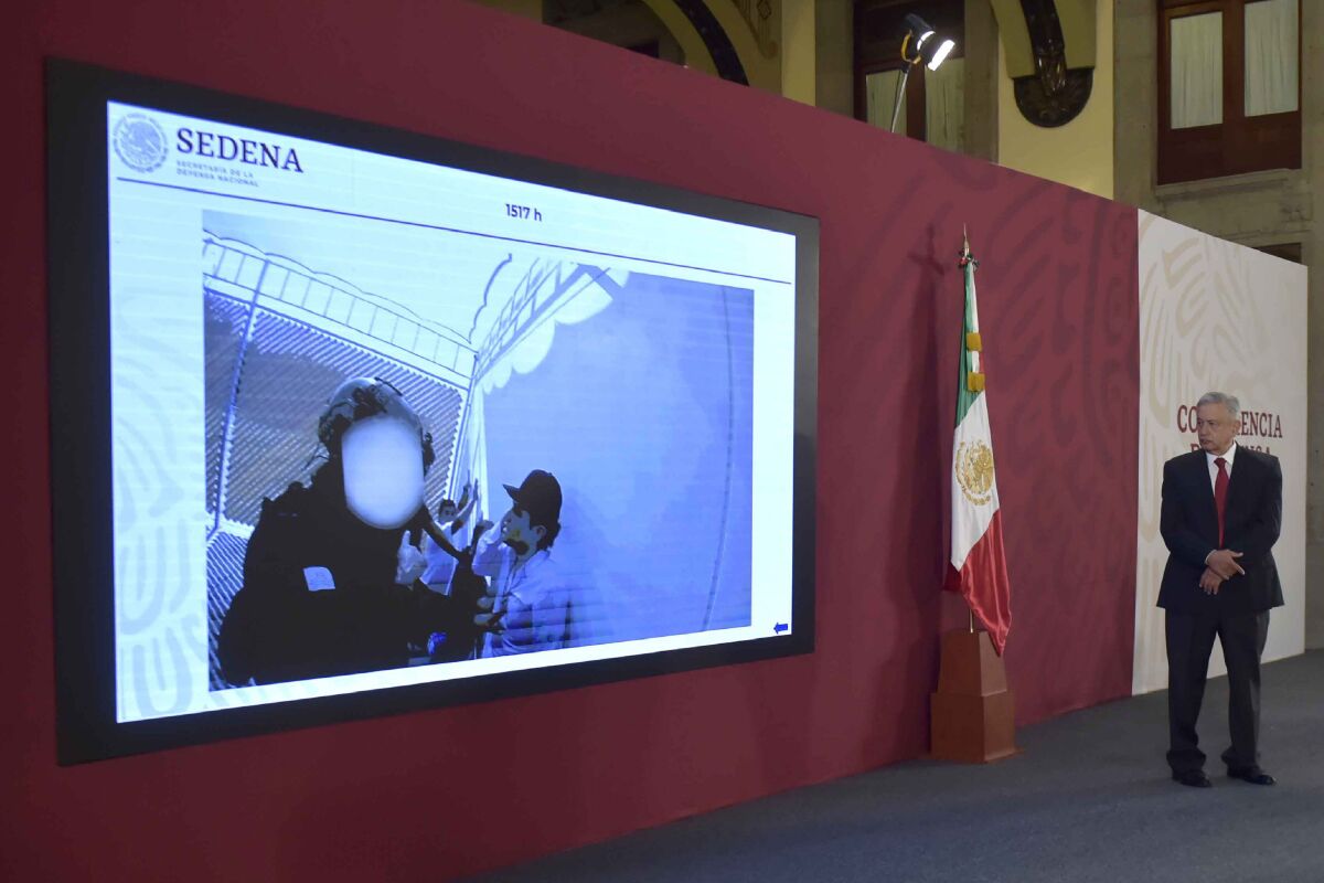 Mexico's President Andres Manuel Lopez Obrador watches a video of the capture of Ovidio Guzman Lopez