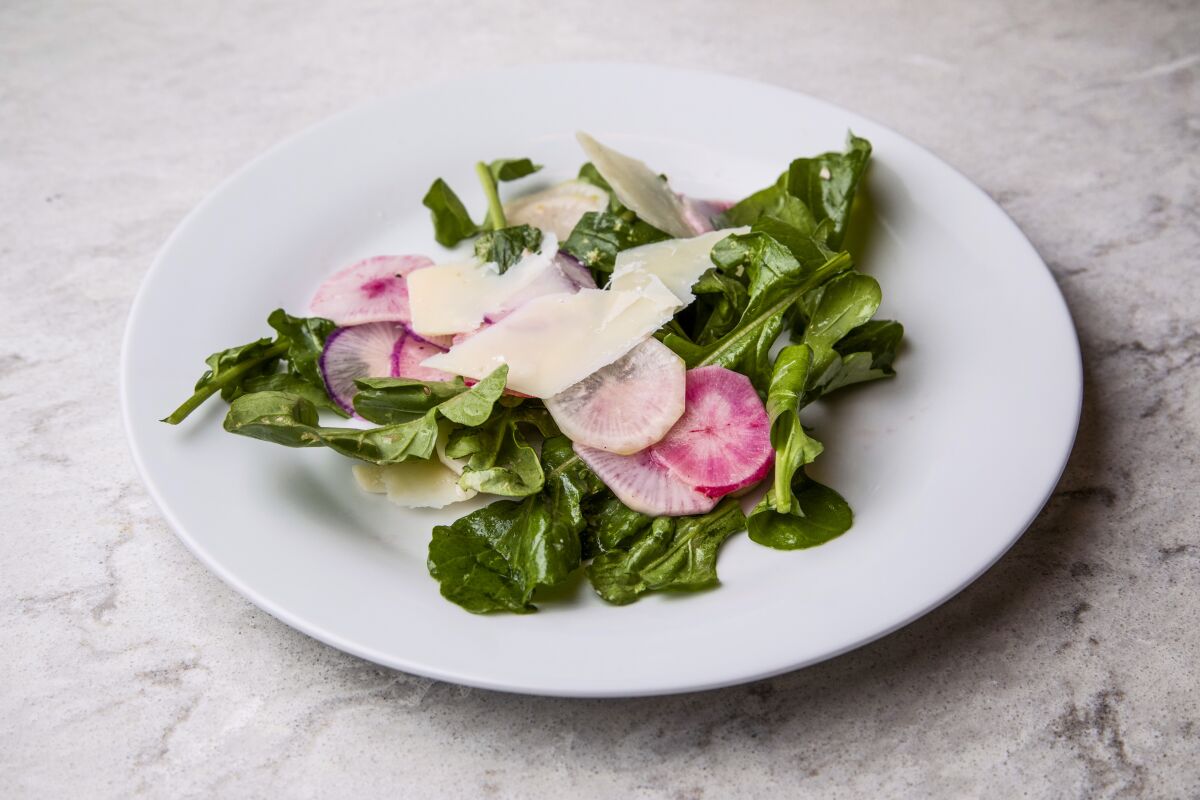 A salad with lettuce and radishes