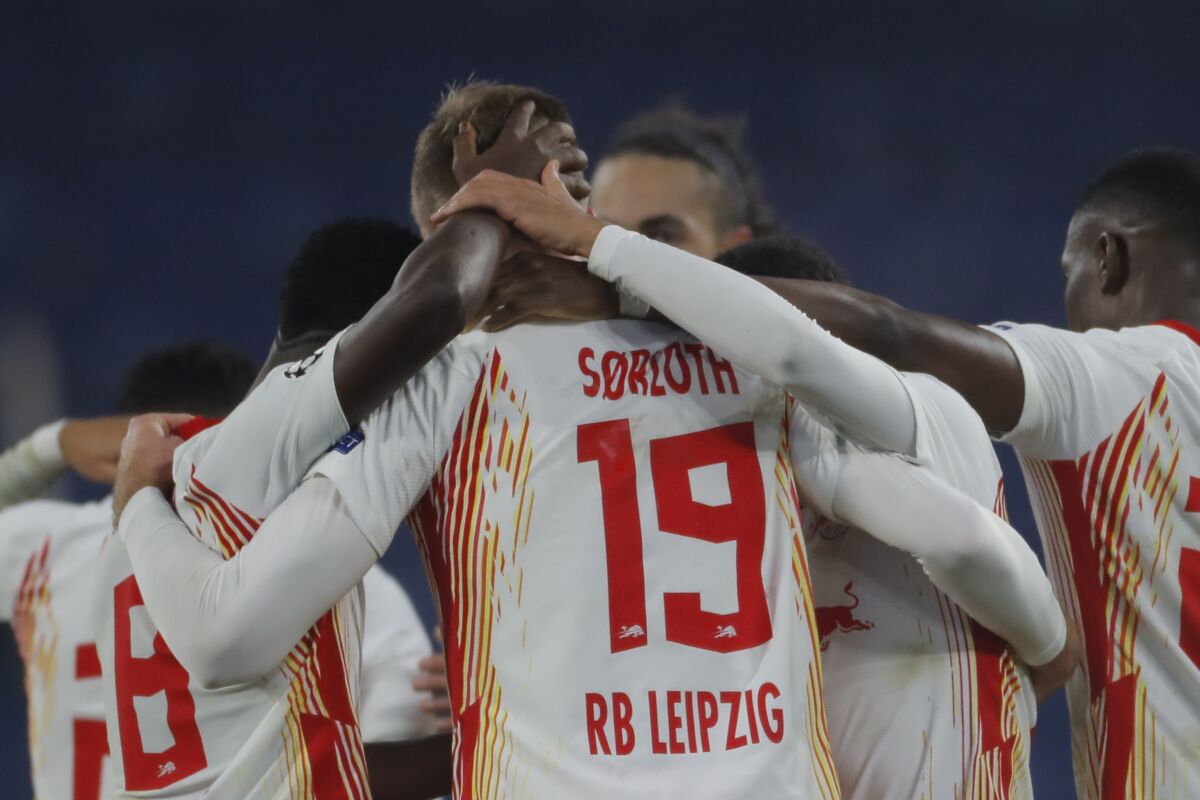 Leipzig's Alexander Sorloth, center, celebrates with teammates his side's fourth goal during the Champions League group H soccer match between Istanbul Basaksehir and RB Leipzig at Fatih Terim Stadium in Istanbul, Wednesday, Dec. 2, 2020. Leipzig won 4-3. (AP Photo)