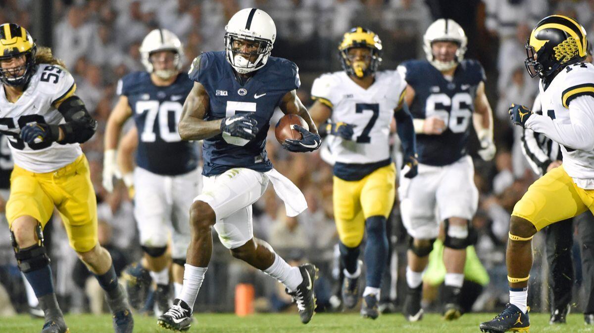 Penn State's DaeSean Hamilton scampers for yardage against Michigan during Saturday's game.