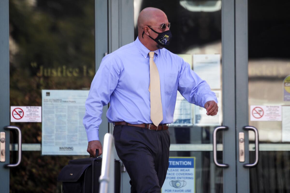 John J. Olivas exits the federal courthouse in Riverside.