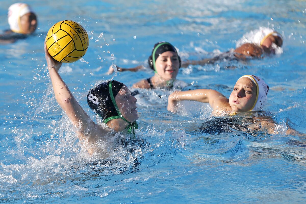 Costa Mesa's Addie Juelfs (8) shoots and scores during the Battle for the Bell girls' water polo game against Estancia.