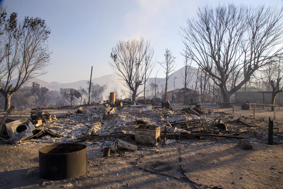 Properties still smolder Saturday morning after the Erskine Fire in Weldon.