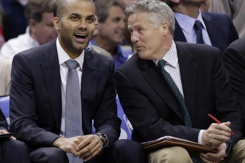 San Antonio Spurs assistant coach Brett Brown, right, speaks with guard Tony Parker during a game in March. The Philadelphia 76ers have hired Brown as their new head coach.