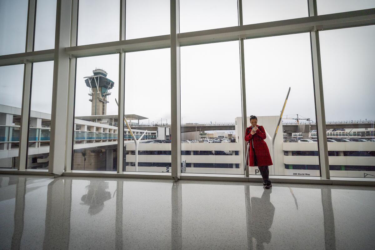 A traveler who waits within the Delta Airlines terminal at Los Angeles International Airport