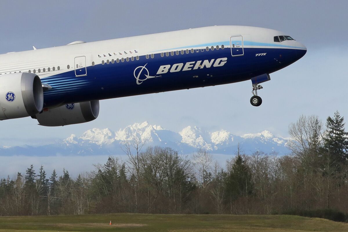 A Boeing 777X airplane takes off Jan. 25 at Paine Field in Everett, Wash.