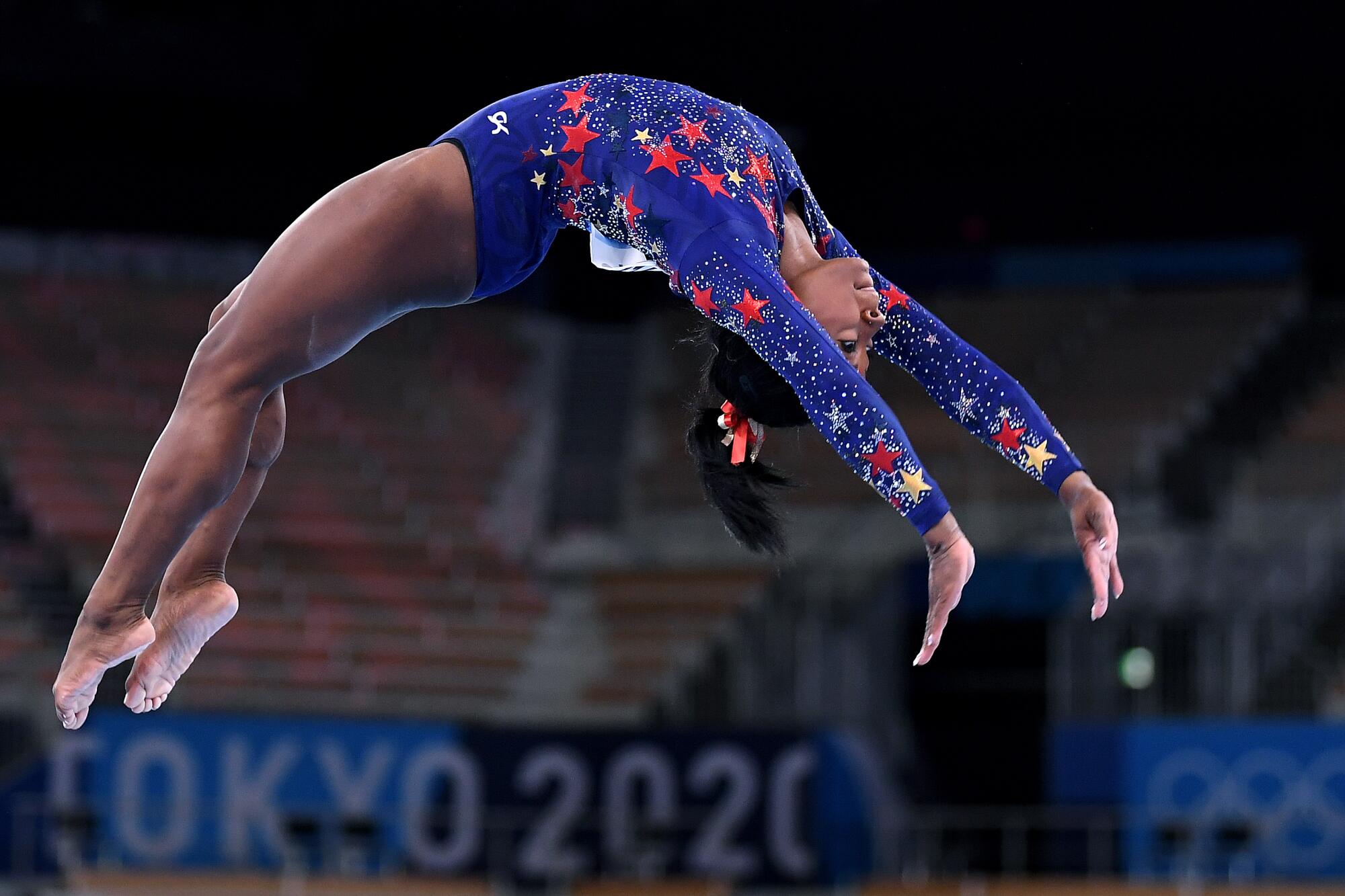 Simone Biles competes on the beam in the women's team qualifying at the 2020 Tokyo Olympics.