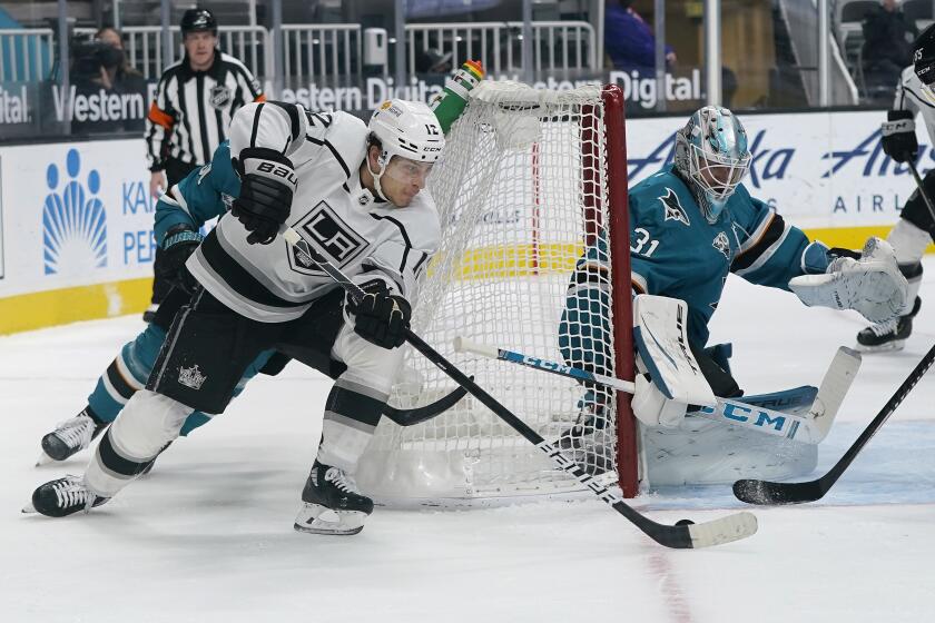 Los Angeles Kings center Trevor Moore (12) skates toward San Jose Sharks goaltender Martin Jones (31) during the second period of an NHL hockey game in San Jose, Calif., Wednesday, March 24, 2021. (AP Photo/Jeff Chiu)