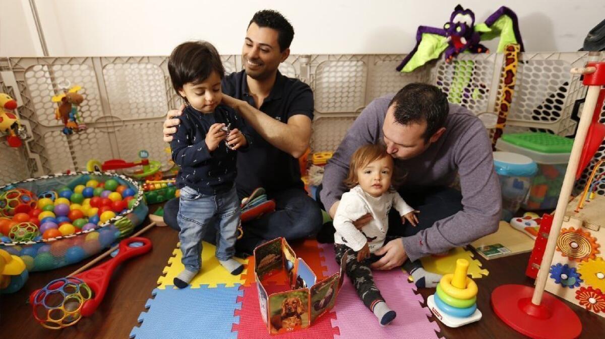 Andrew, right, and Elad Dvash-Banks, married parents of twins Ethan, left, and Aiden, at their Los Angeles home in 2018. The boys are now 2.