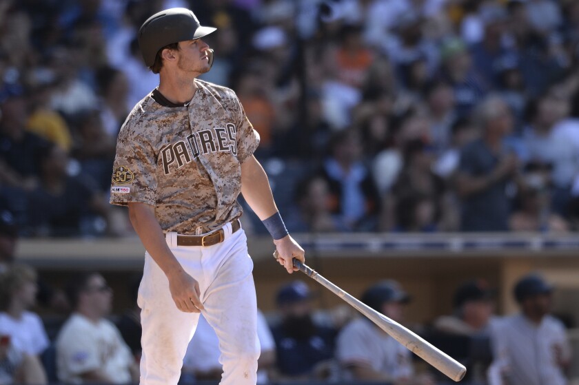 The Padres' Wil Myers watches his two-run home run during the ninth inning of a baseball game against the San Francisco Giants, Sunday, July 28, 2019, in San Diego.