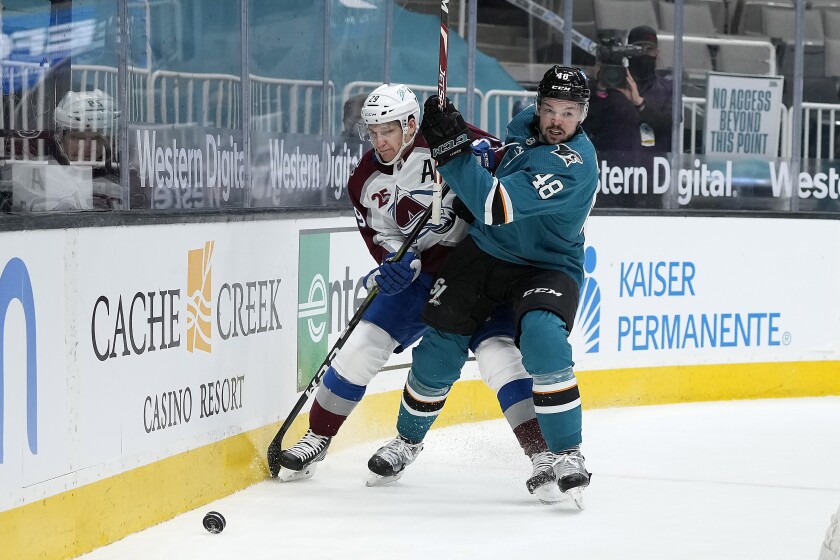 Colorado Avalanche center Nathan MacKinnon (29) battles for the puck against San Jose Sharks center Tomas Hertl (48) during the first period of an NHL hockey game in San Jose, Calif., on Wednesday, May 5, 2021. (AP Photo/Tony Avelar)