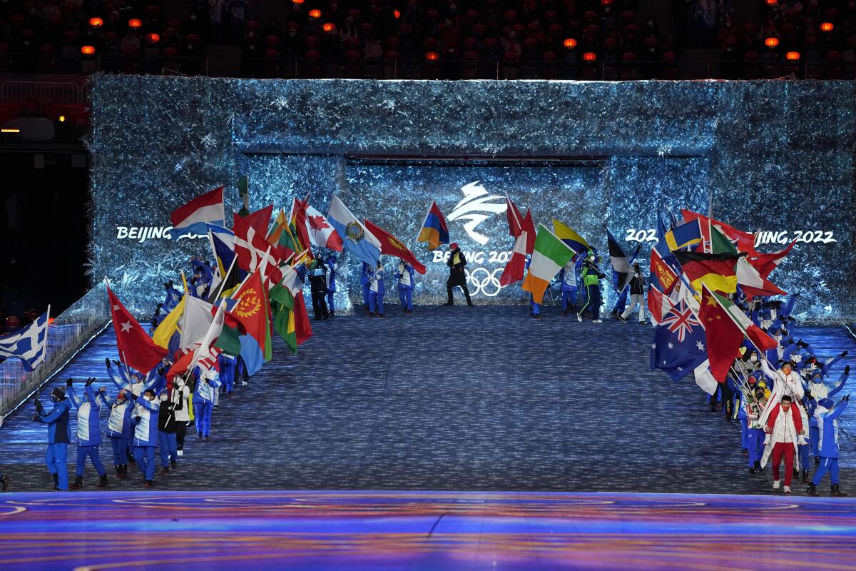 Flag bearers march at the 2022 Olympics.