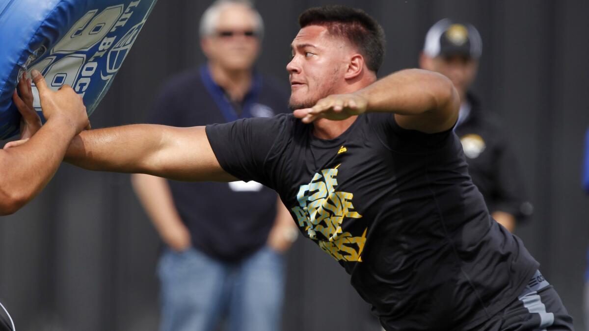 Offensive lineman Xavier Su'a-Filo works out during UCLA's pro day at Spaulding Field in March. Su'a-Filo could end up be a first-round selection in the NFL draft.