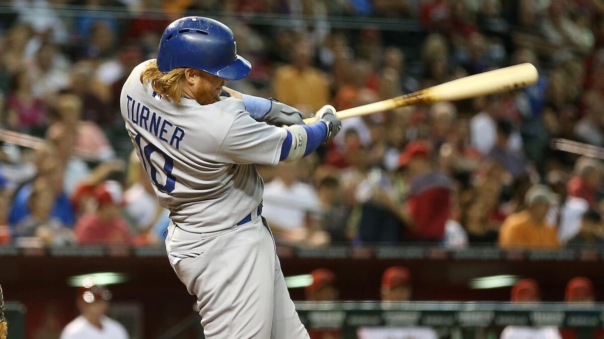 Dodgers third baseman Justin Turner hits a run-scoring single in the fourth inning of the team's 9-5 win over the Arizona Diamondbacks on Tuesday.