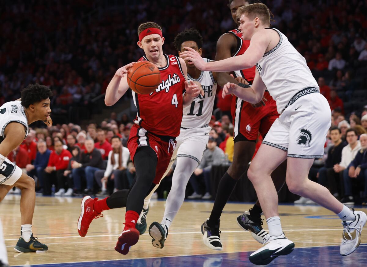 Rutgers guard Paul Mulcahy (4) drives to the basket against Michigan State forward Jaxon Kohler (0) during the first half of an NCAA college basketball game in New York, Saturday, Feb. 4, 2023. (AP Photo/Noah K. Murray)