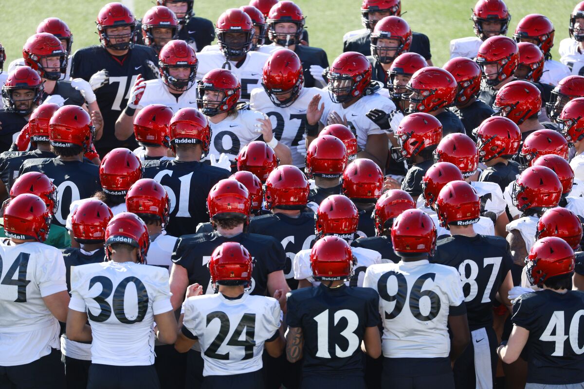 The San Diego State football team gathers before its first spring practice on Monday. 