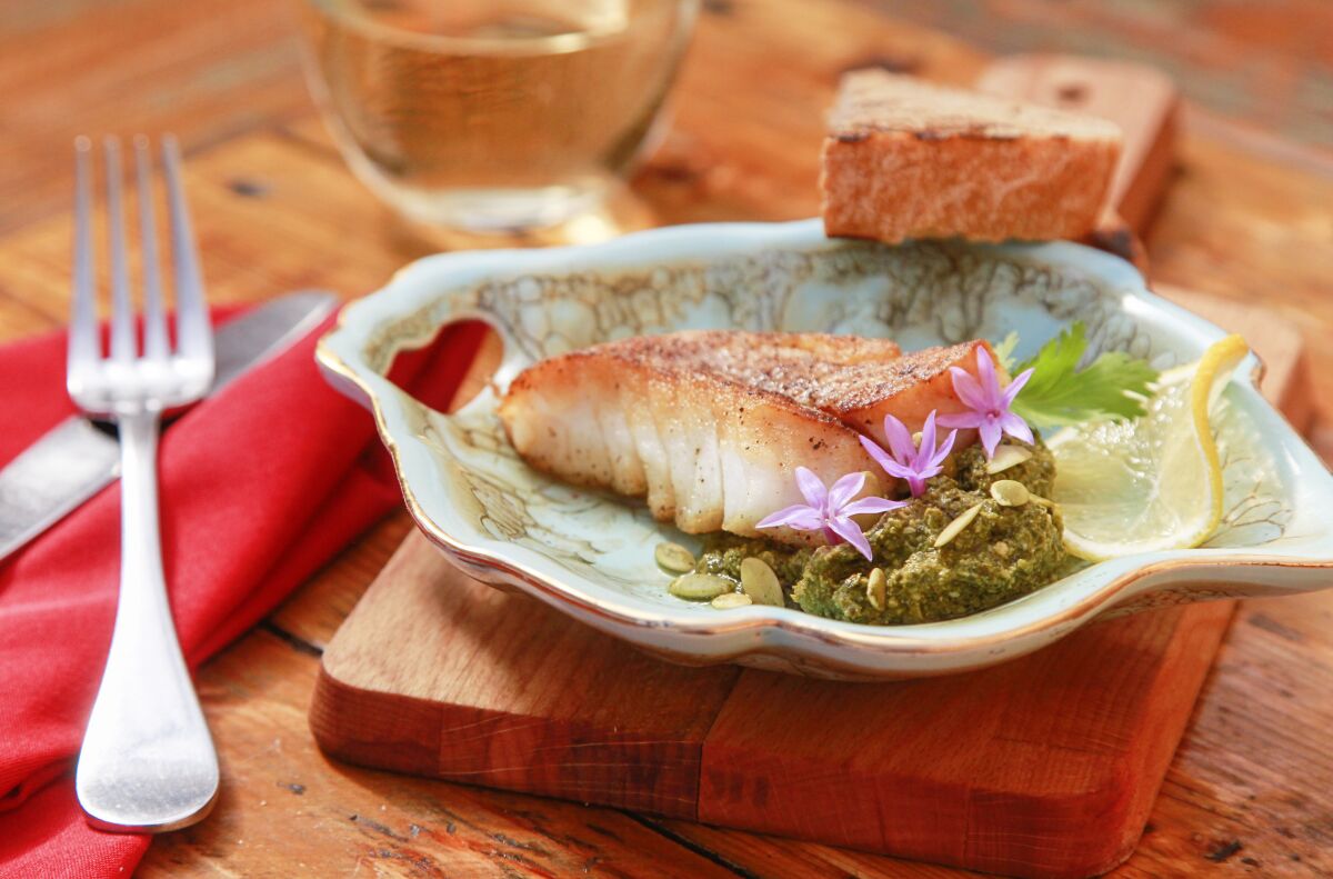 Coral Strong's Grilled Gold Spotted Bass with Radish Leaf Pipian Pesto and Whole Wheat Bread.