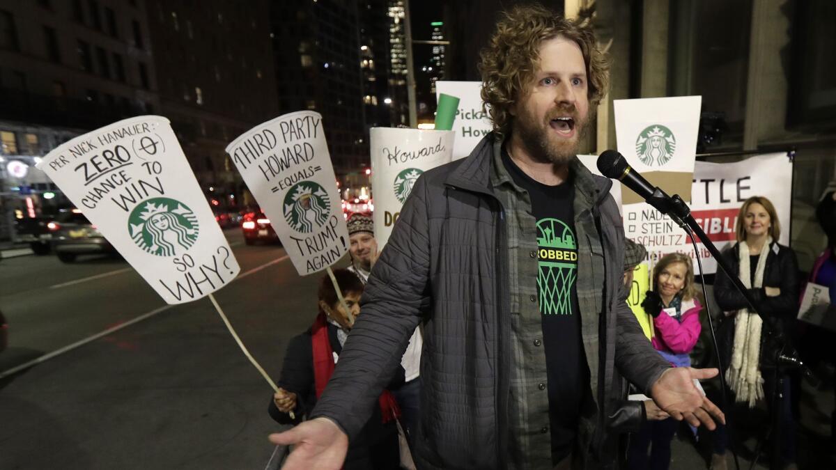Jason Reid, director of the "Sonicsgate" documentary film, speaks during a protest outside a book promotion event held by former Starbucks CEO Howard Schultz in Seattle.