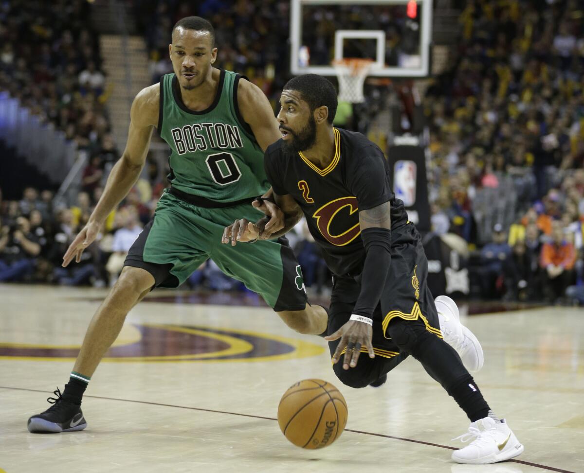 Cavaliers point guard Kyrie Irving (2) drives against Celtics guard Avery Bradley (0) in the second half on Dec. 29.