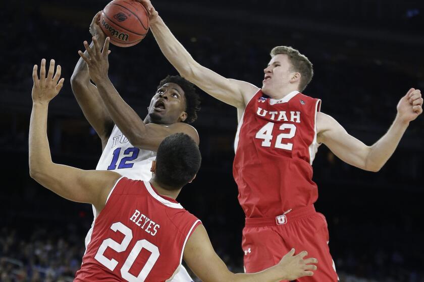 Utah center Jakob Poeltl (42) blocks a shot from Duke forward Justise Winslow in the NCAA Tournament.