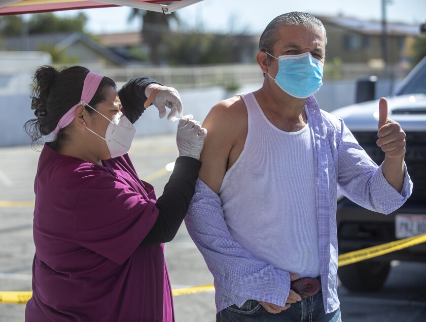 Ponciano Sanchez gives a thumbs up sign as he receives a dose of COVID-19 vaccine at a pop-up site in Pacoima. 