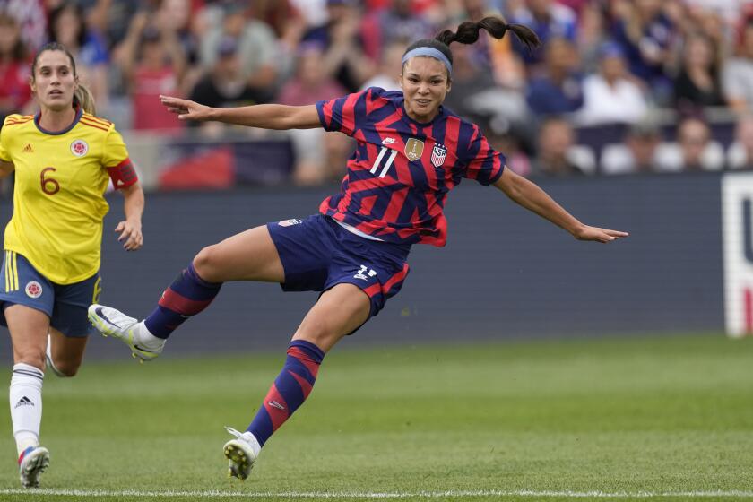 U.S. forward Sophia Smith, front, comes back down to the pitch after kicking the ball, next Colombia midfielder Daniela Montoya during the first half of an international friendly soccer match Saturday, June 25, 2022, in Commerce City, Colo. (AP Photo/David Zalubowski)