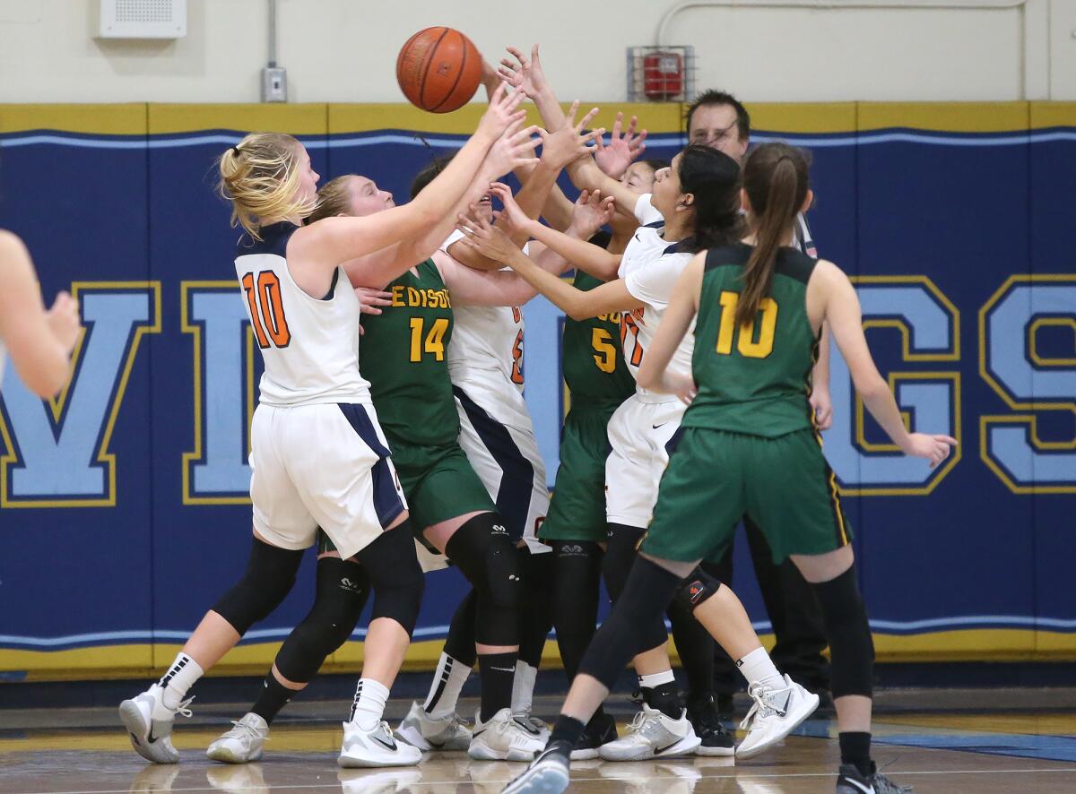 Edison and Cypress battle for a rebound in the last seconds of the game in the Larry Doyle and Dan Wiley Tournament of Champions at Marina High on Thursday.