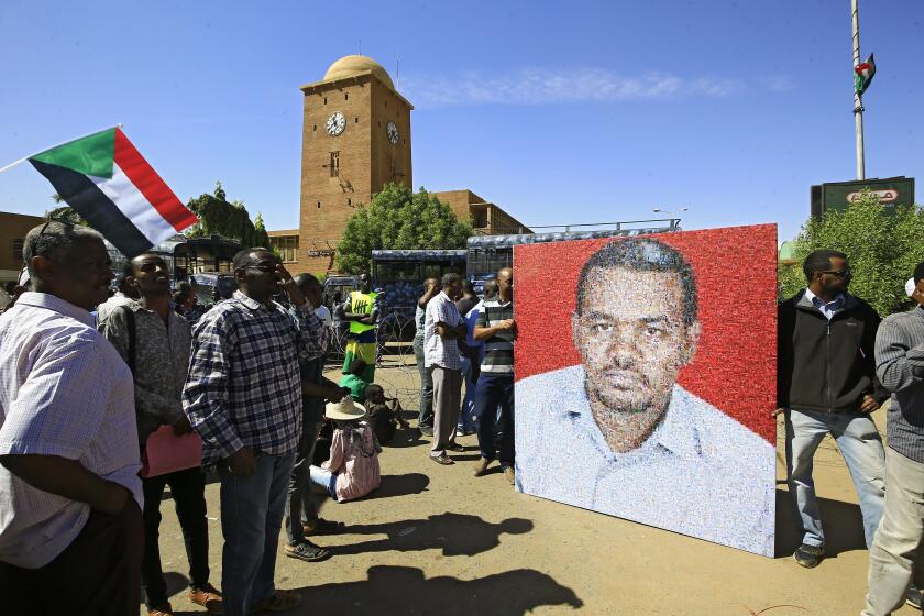 A picture of slain protester Ahmed al-Khair is displayed during a rally outside a courthouse in Omdurman, Sudan, on Monday. Al-Khair, a schoolteacher, was detained on Jan. 31 in the eastern province of Kassala and was reported dead two days later.