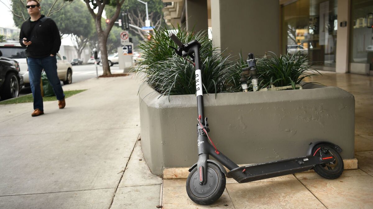 A Bird scooter stands along 5th Avenue in Santa Monica.